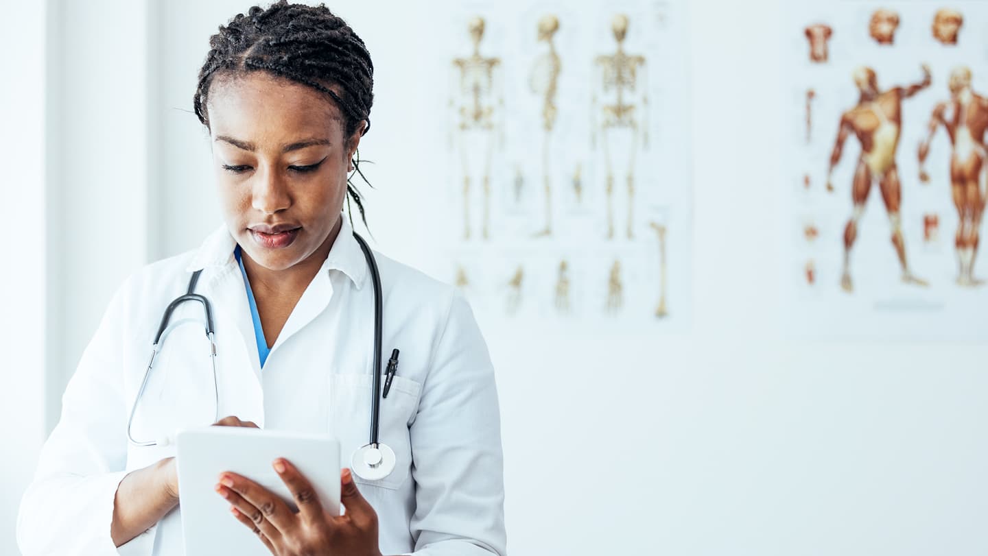 Healthcare professional using a tablet during a care conversation